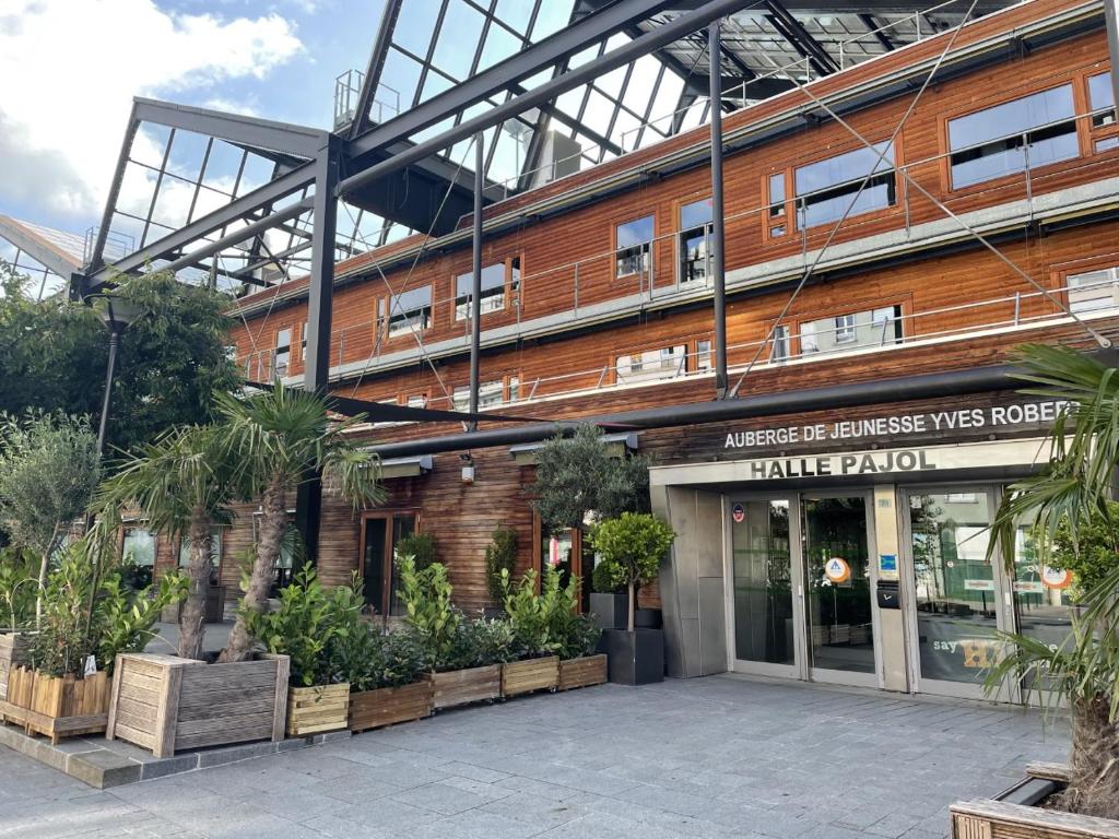 a building with plants in front of it at Auberge de Jeunesse HI Paris Yves Robert in Paris