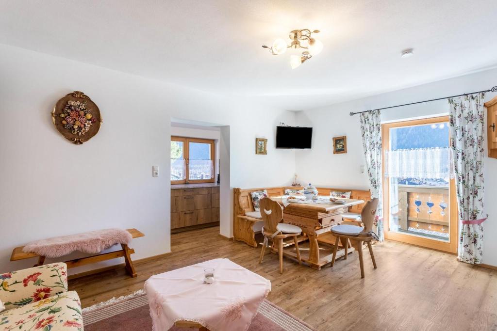 un soggiorno con tavolo e una sala da pranzo di Ferienwohnung Rosenquarz a Mittenwald