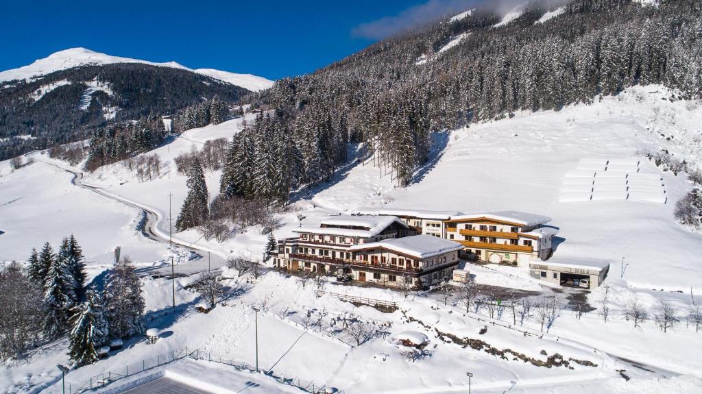 um alojamento de esqui na neve com uma montanha em Jugend- und Familienhotel Venedigerhof em Neukirchen am Großvenediger