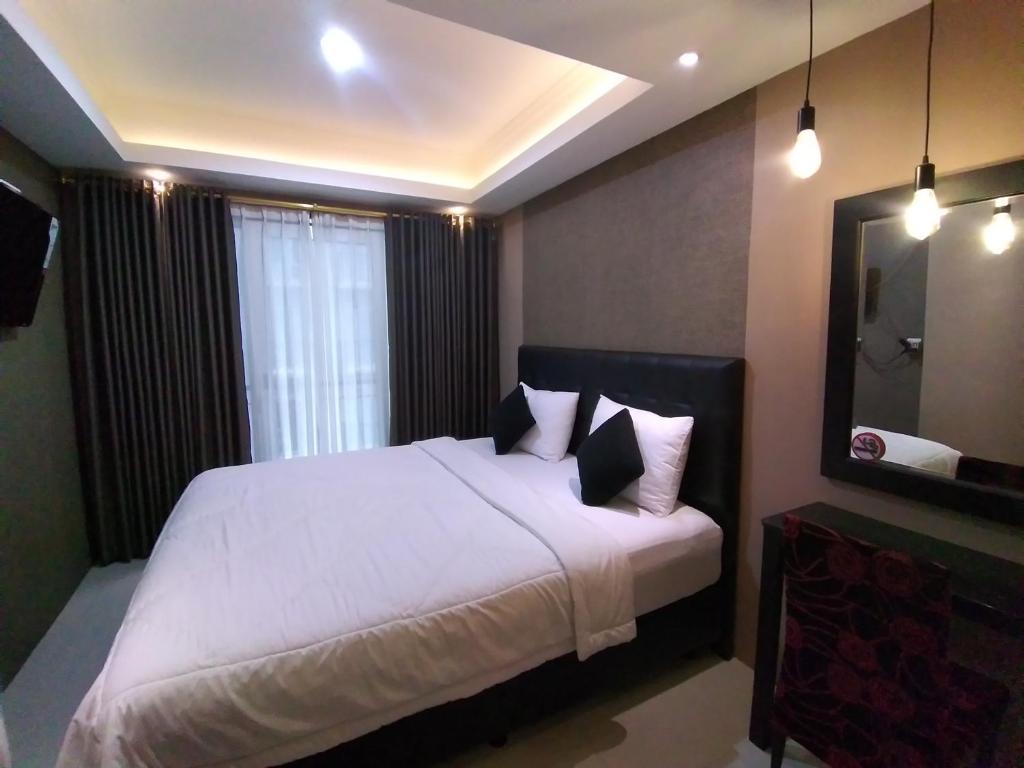 เตียงในห้องที่ Apartement Grand Asia Afrika Bandung by House Of Tofi