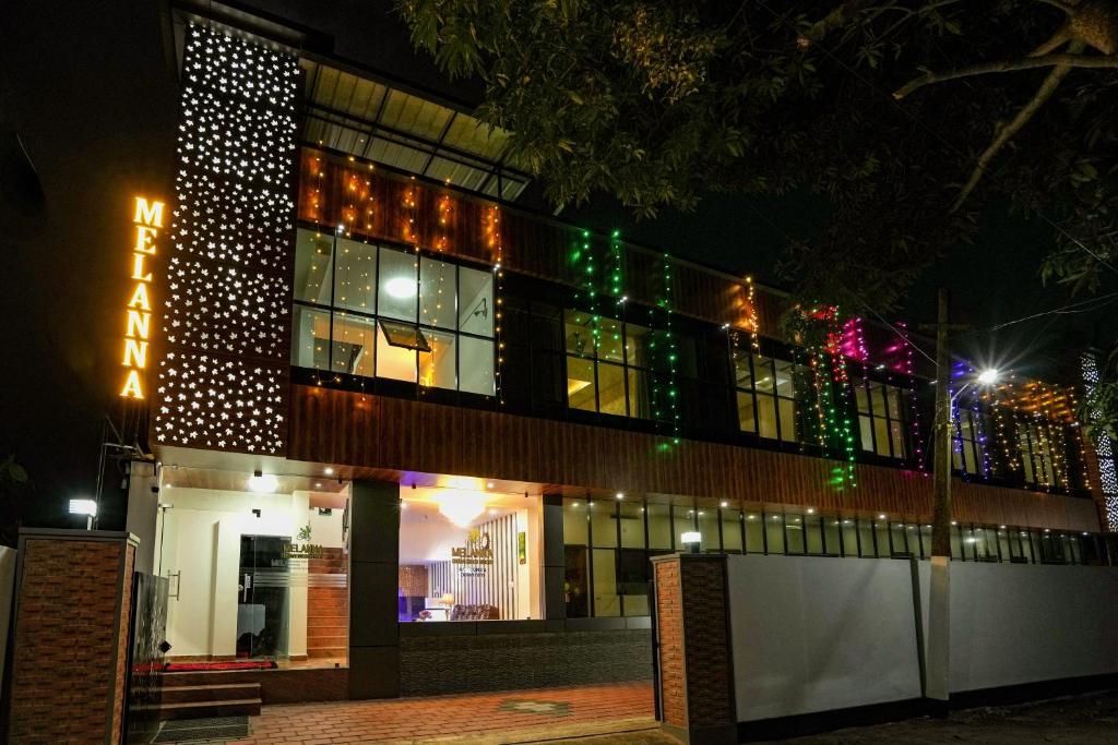 a building decorated with christmas lights at night at Melanna Cherai Beach Resorts in Cherai Beach