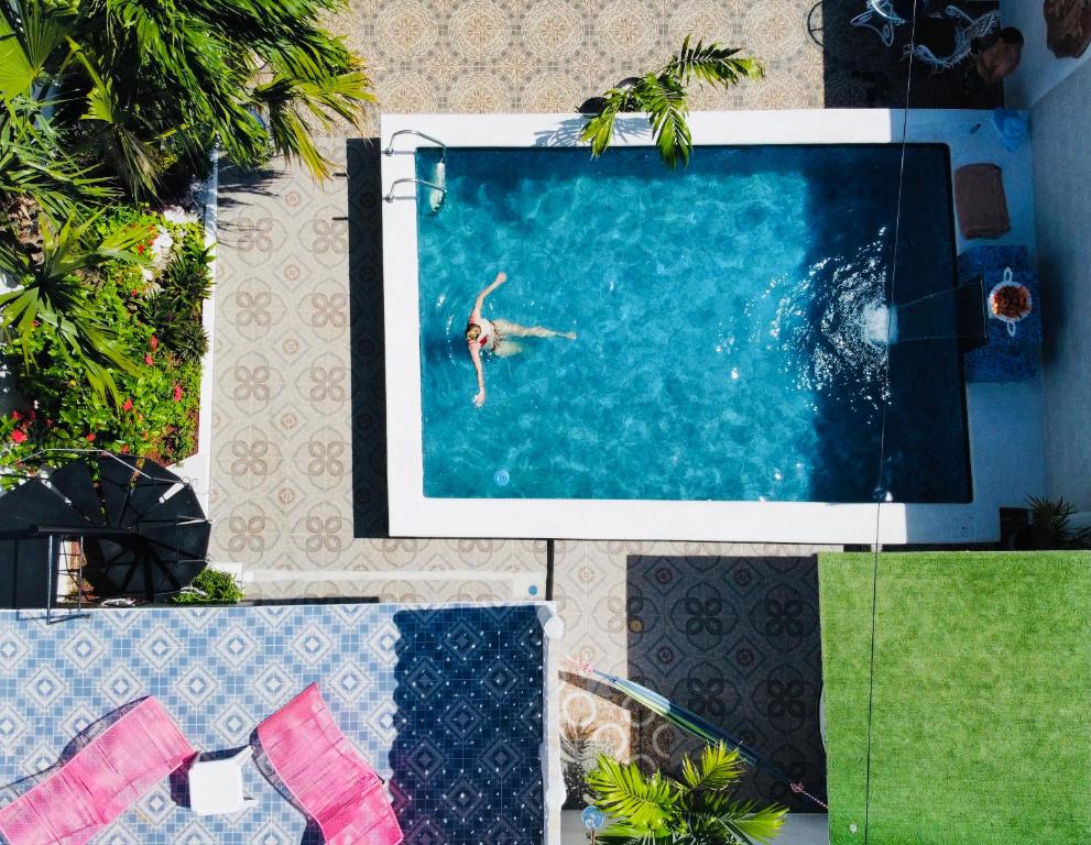 a person swimming in a swimming pool at The Quetzal in Cancún