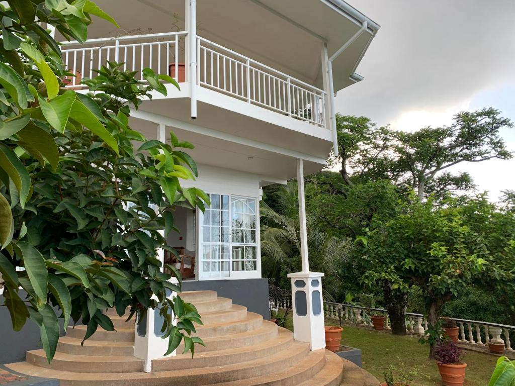 a house with a staircase leading up to it at Beau Séjour Hotel in Victoria