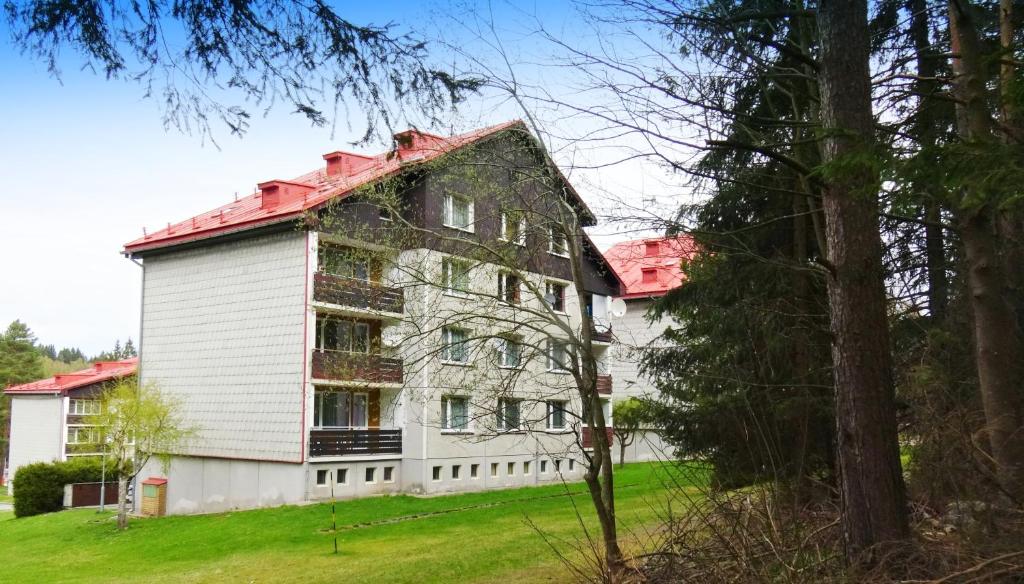 an old white house with a red roof at Apartmán v Srní in Srní