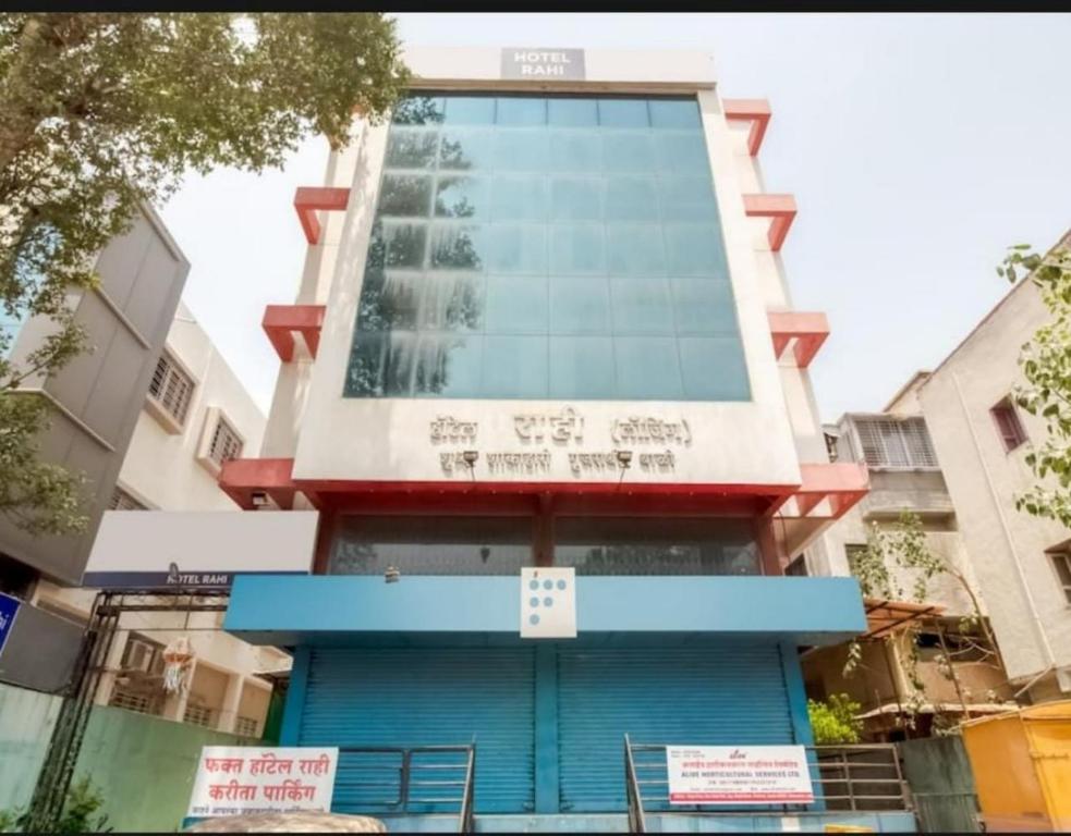 a building in the city with signs on it at Hotel Rahi in Nashik