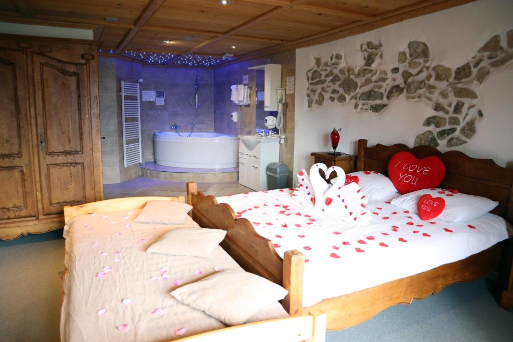 ein Schlafzimmer mit zwei Betten mit Herz drauf in der Unterkunft Gruyère Rooms in Gruyères