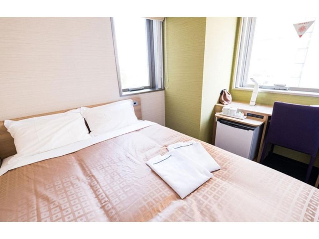 En eller flere senge i et værelse på Meet Inn Narita - Vacation STAY 43769v