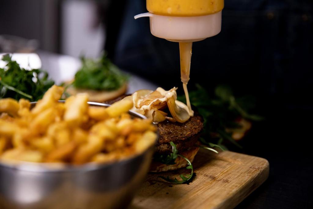 a sandwich with cheese and french fries on a table at The People - Tours in Tours