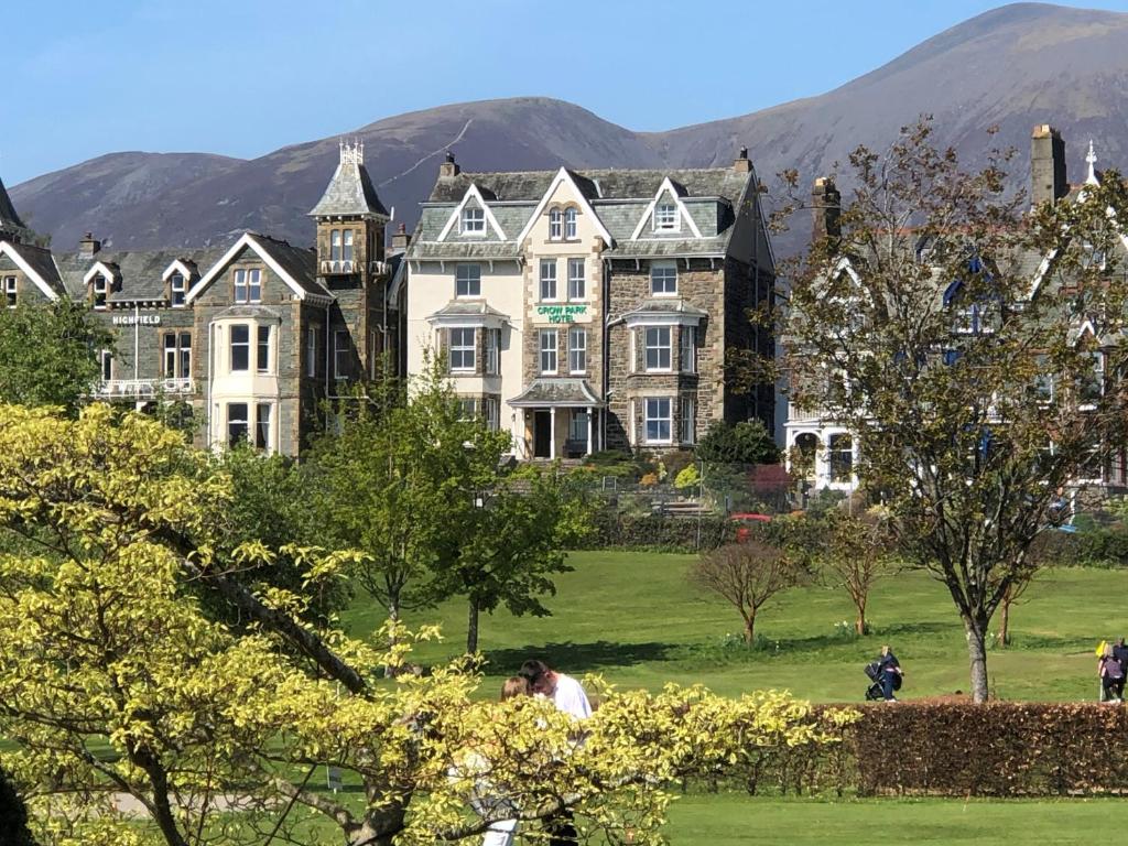 una grande casa in un parco con montagne sullo sfondo di Crow Park Hotel a Keswick