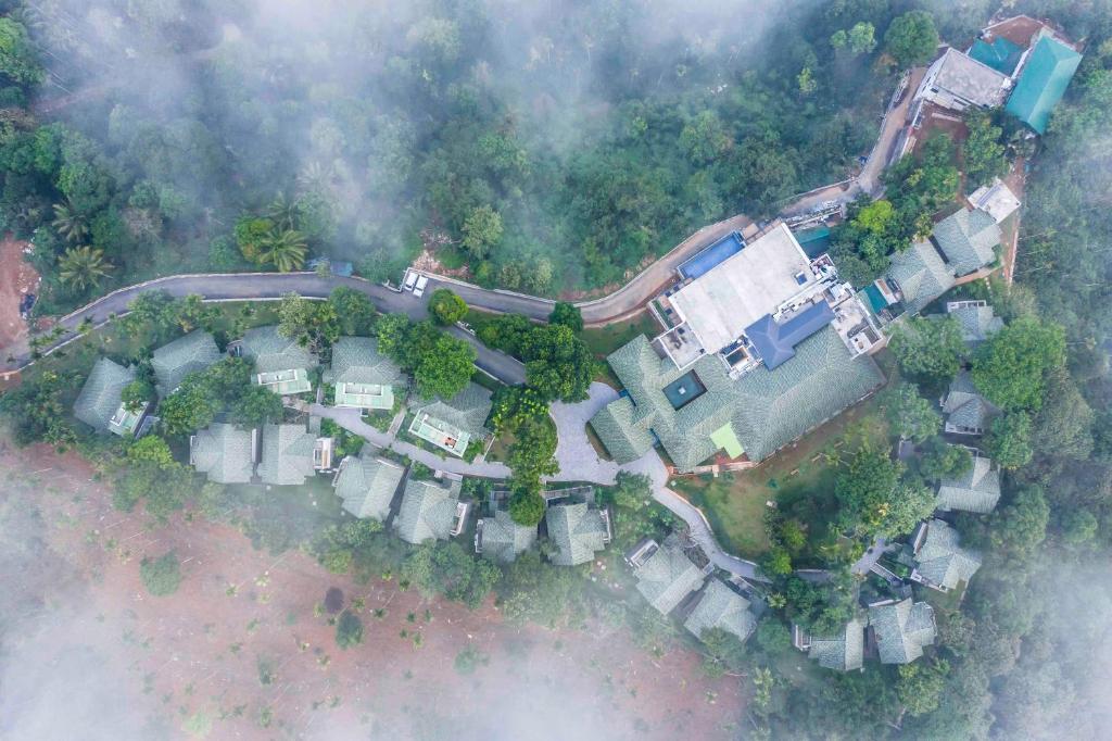 an aerial view of a house in the forest at Great Trails Wayanad by GRT Hotels in Wayanad