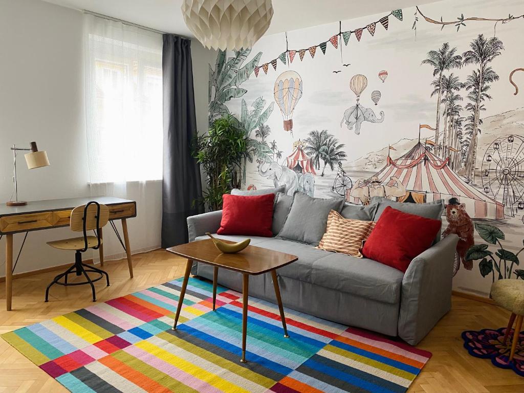 a living room with a couch and a table at Der Stadtzirkus in Klagenfurt