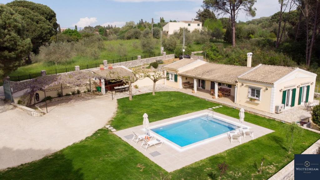 an aerial view of a house with a swimming pool at Villa Pine Forest in Corfu Town