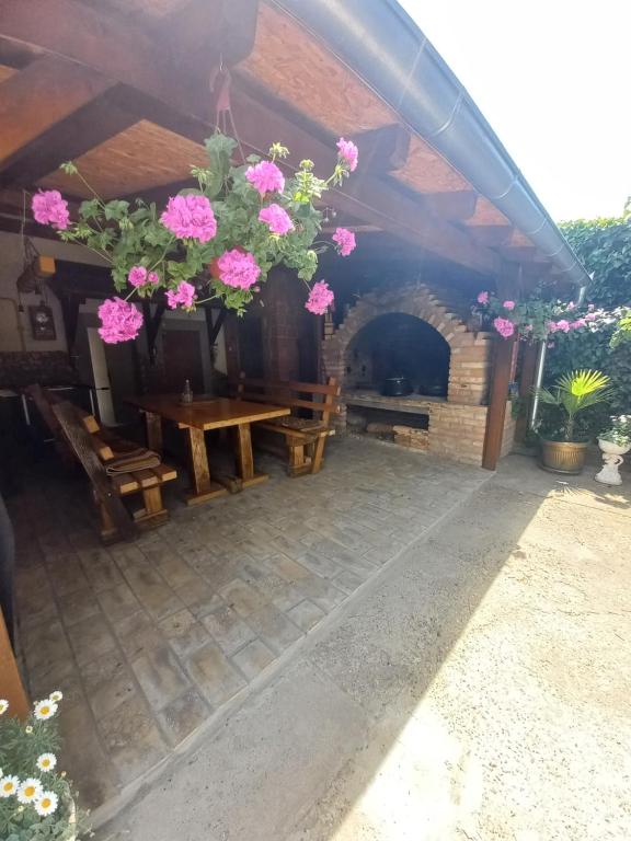 um pátio com uma mesa de madeira e uma lareira em Dvorska oaza em Sremski Karlovci