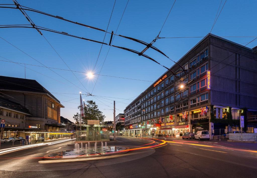 eine Stadtstraße in der Nacht mit Verkehr in der Unterkunft Continental Hotel Lausanne in Lausanne