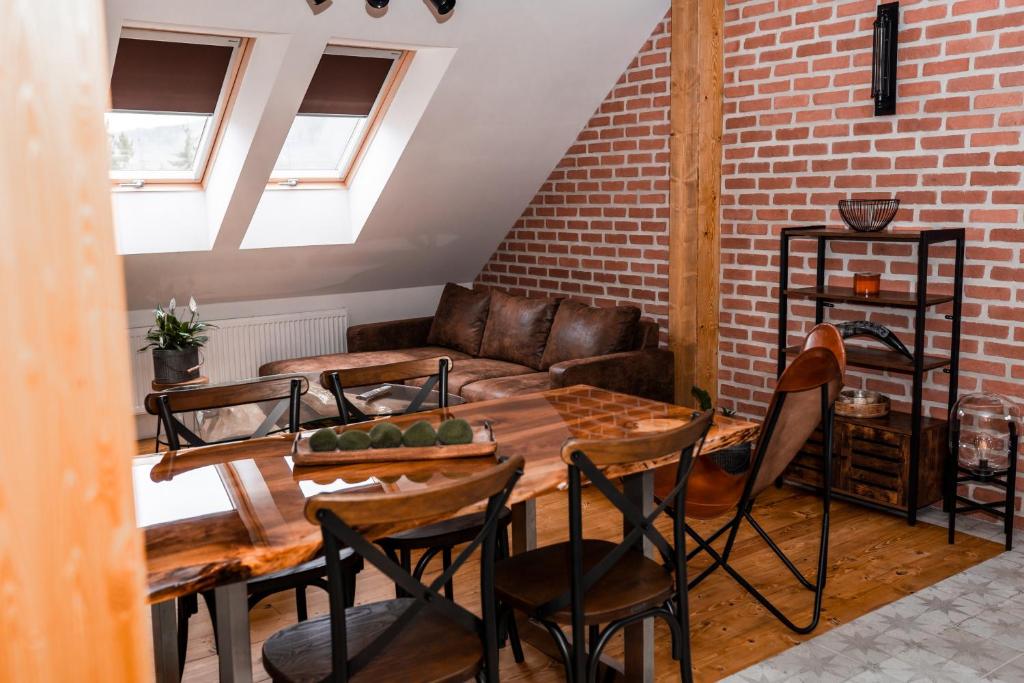 a living room with a couch and a table and chairs at PARKHOUSE in Rožňava