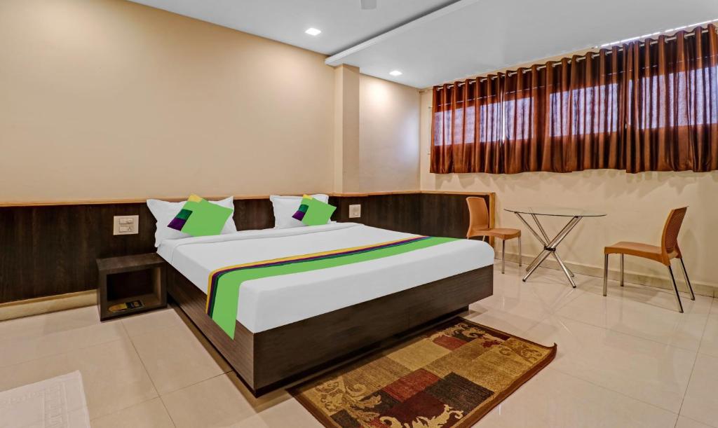 A bed or beds in a room at Treebo Surya Yatri Niwas