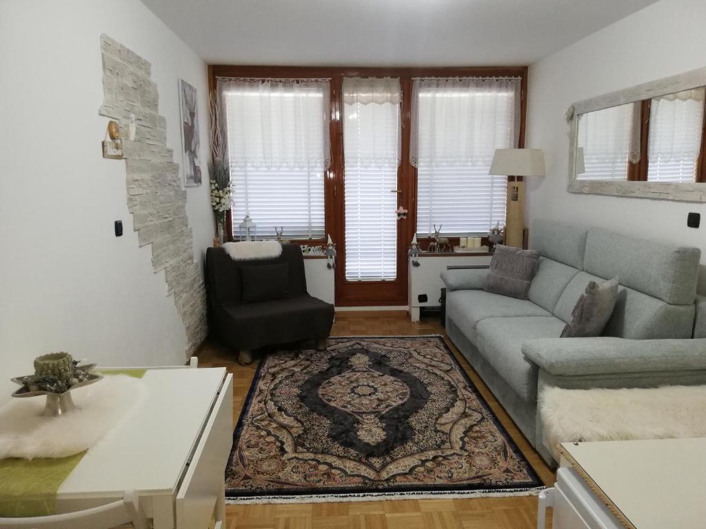 a living room with a couch and a chair at Condominio - Guglielmo Tell in Sestriere