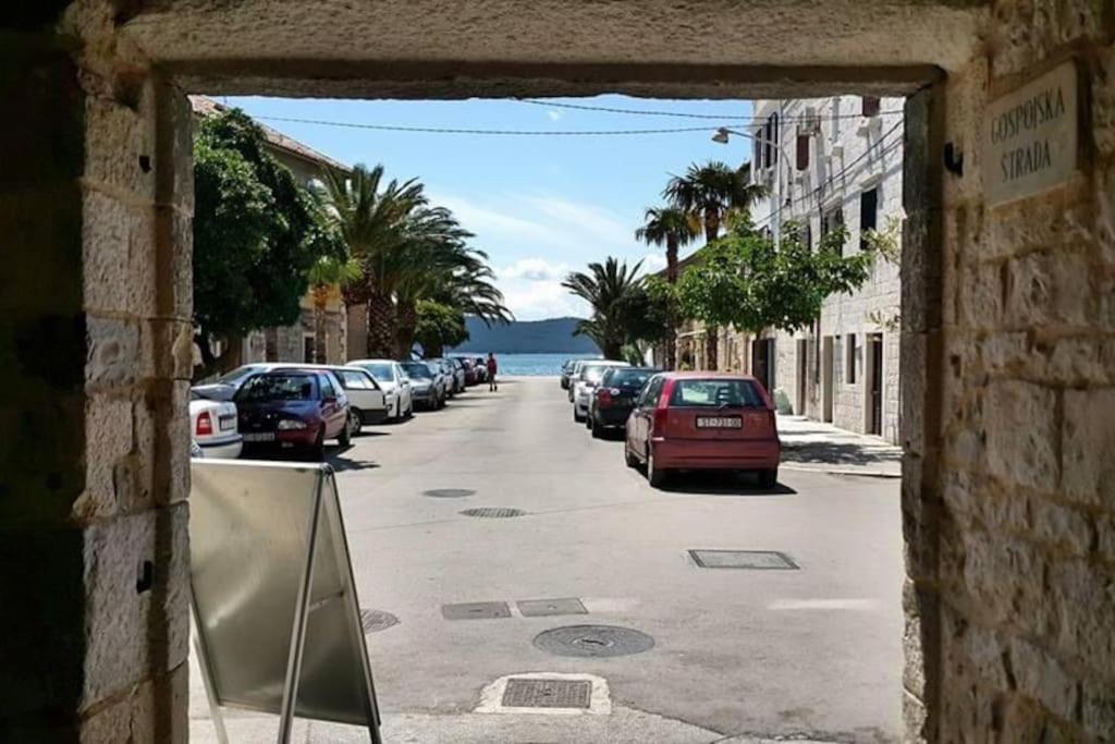 vistas a una calle con coches aparcados en la carretera en Stone house Castellum, en Kaštela