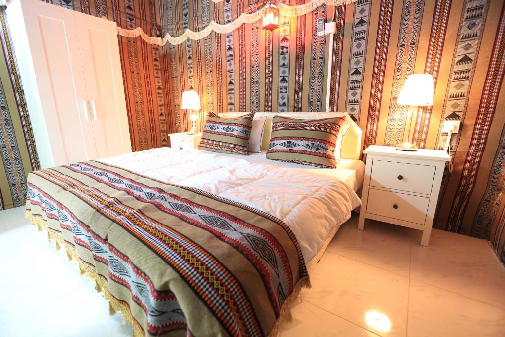 a bedroom with a bed with two pillows on it at بيرحاء إبراء للسياحة in Ibrā