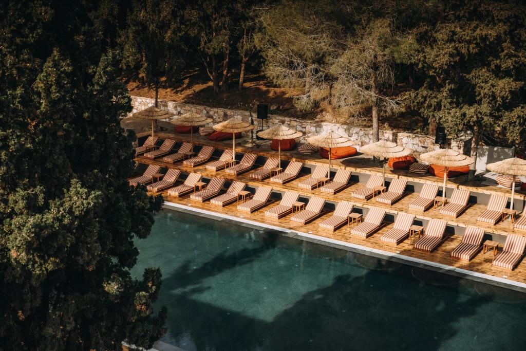 una vista aérea de una piscina con sillas y sombrillas en Cook's Club Ialysos Rhodes, en Ialisos