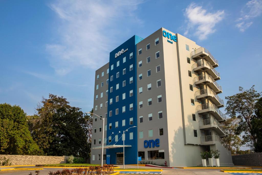 a hotel with a blue and white building at One Tapachula in Tapachula