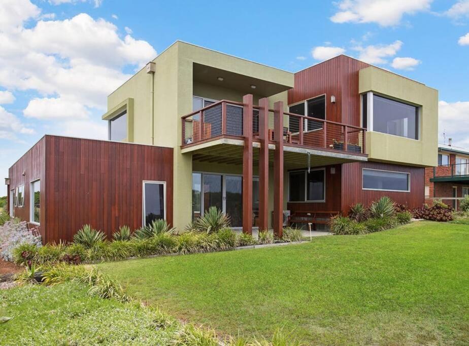 a house with a green lawn in front of it at Martyrs Lookout - Luxury Accommodation in Peterborough