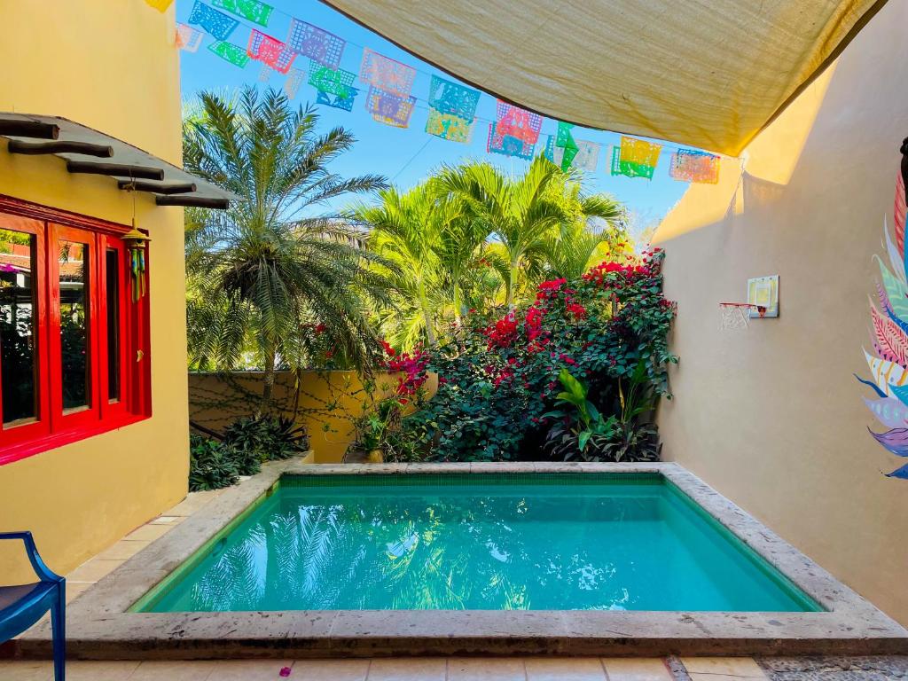 a swimming pool in the backyard of a house at Casa Boho 1 in Sayulita