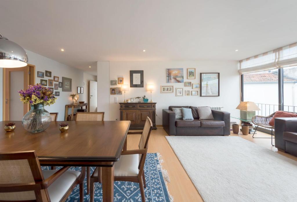 a living room with a table and a couch at Between River and Sea Porto Apartment in Porto