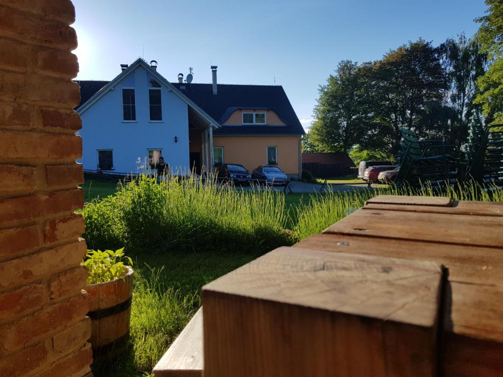 a house and a yard with a wooden fence at Apartments Cederika in Věžovatá Pláně