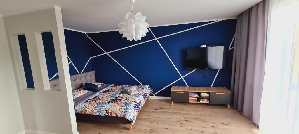 Una cama o camas en una habitación de Apartamenty Diamond na Sportowej