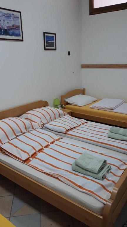 two beds sitting next to each other in a room at Apartment and rooms"Tabašnice"Tuzla centar in Tuzla