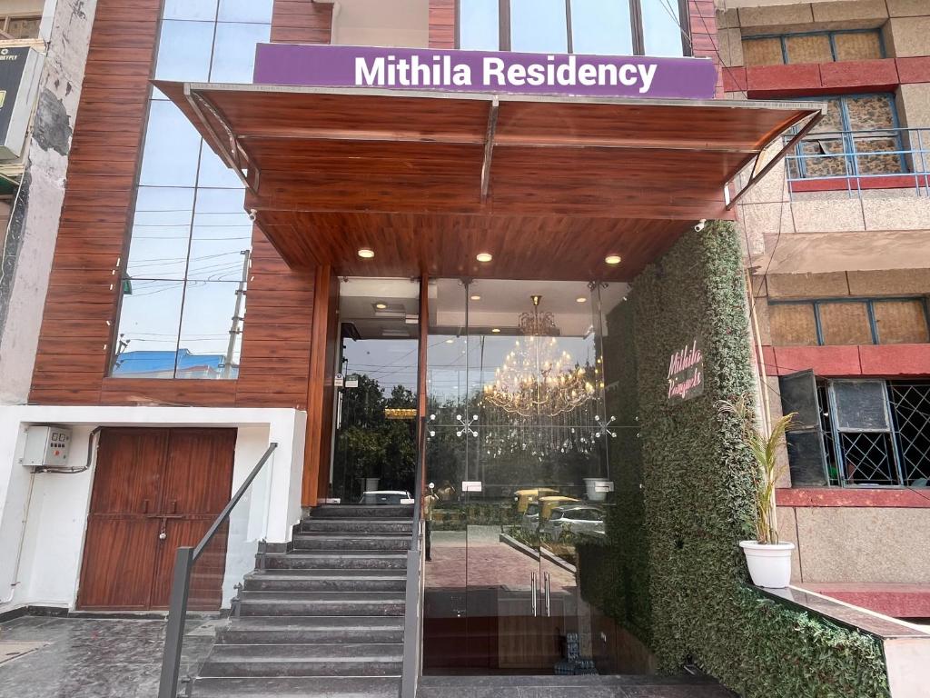 a entrance to a building with a wooden door and stairs at HOTEL TNCS - Couple Friendly Local IDs Accepted in Noida