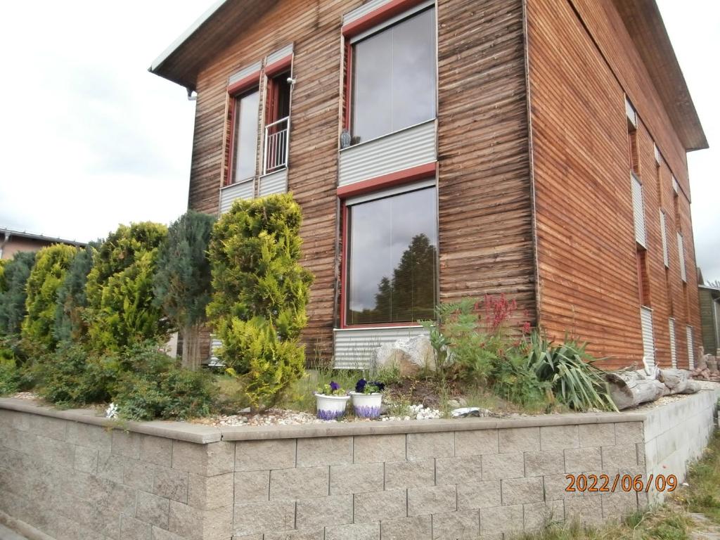 ein Haus mit einer Haltewand davor in der Unterkunft Apartmán v dřevěném domě in Franzensbad