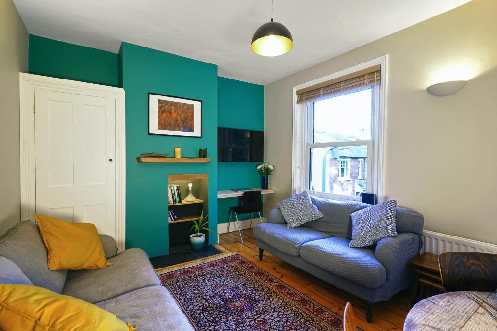 a living room with a couch and a chair at Tastefully Decorated 1-Bed with Free Parking - At Hem in Winchester