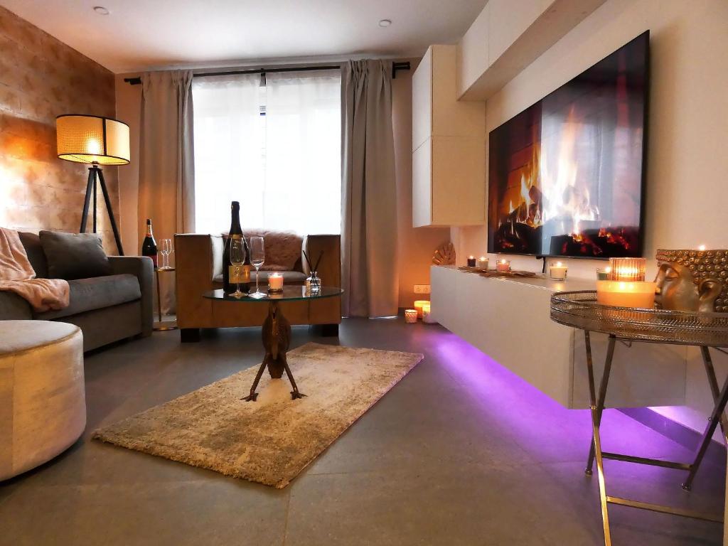 a living room with a dog walking in a room with purple lights at SuiteDreams - Relax Suite Liège in Liège