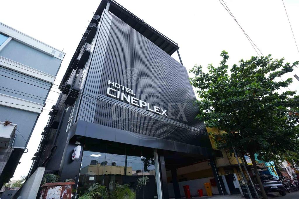 a building with a large sign on the front of it at Hotel Cineplex in Coimbatore