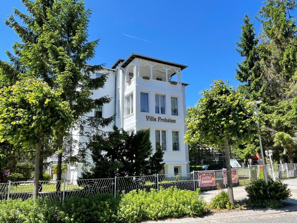 een wit gebouw met een bord erop bij Pension Villa Frohsinn Sellin auf Rügen in Ostseebad Sellin