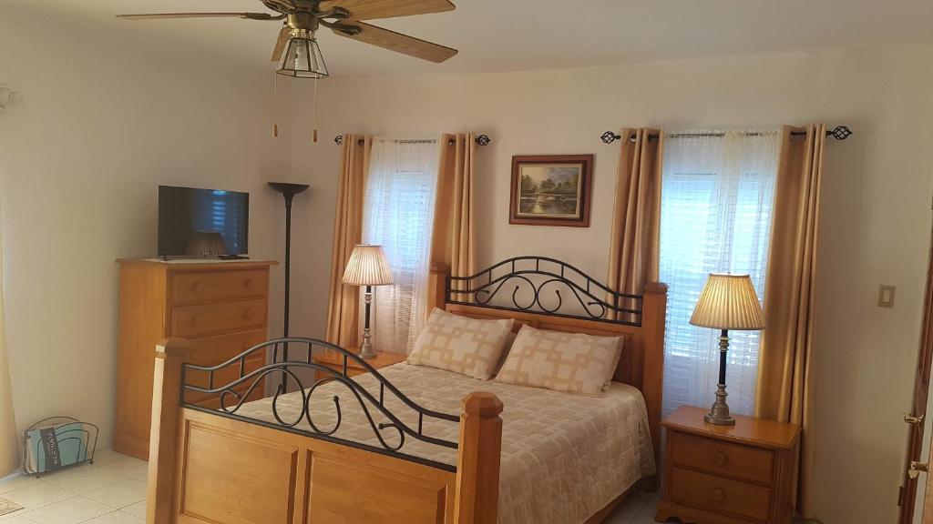 a bedroom with a bed and a ceiling fan at AIRBAB Moon Gate East in Mount Pleasant