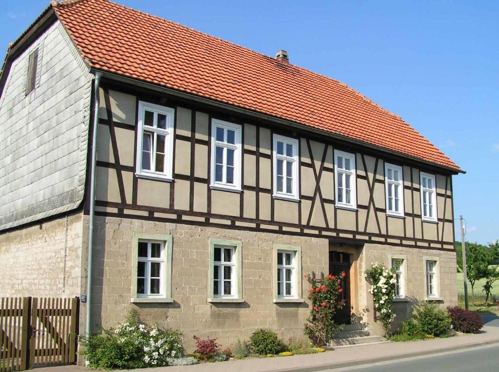 une maison ancienne avec un toit rouge dans l'établissement FeWo Gutendorf, à Bad Berka