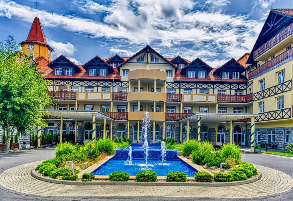 a large building with a fountain in front of it at St Lukas Medical & SPA in Świeradów-Zdrój