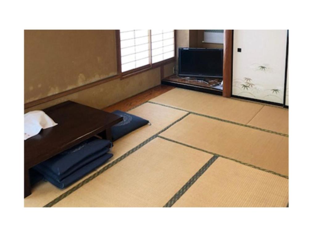 une chambre avec un bureau, une table et une table ainsi qu'une chambre avec dans l'établissement Kagetsu Ryokan - Vacation STAY 04880v, à Shizuoka