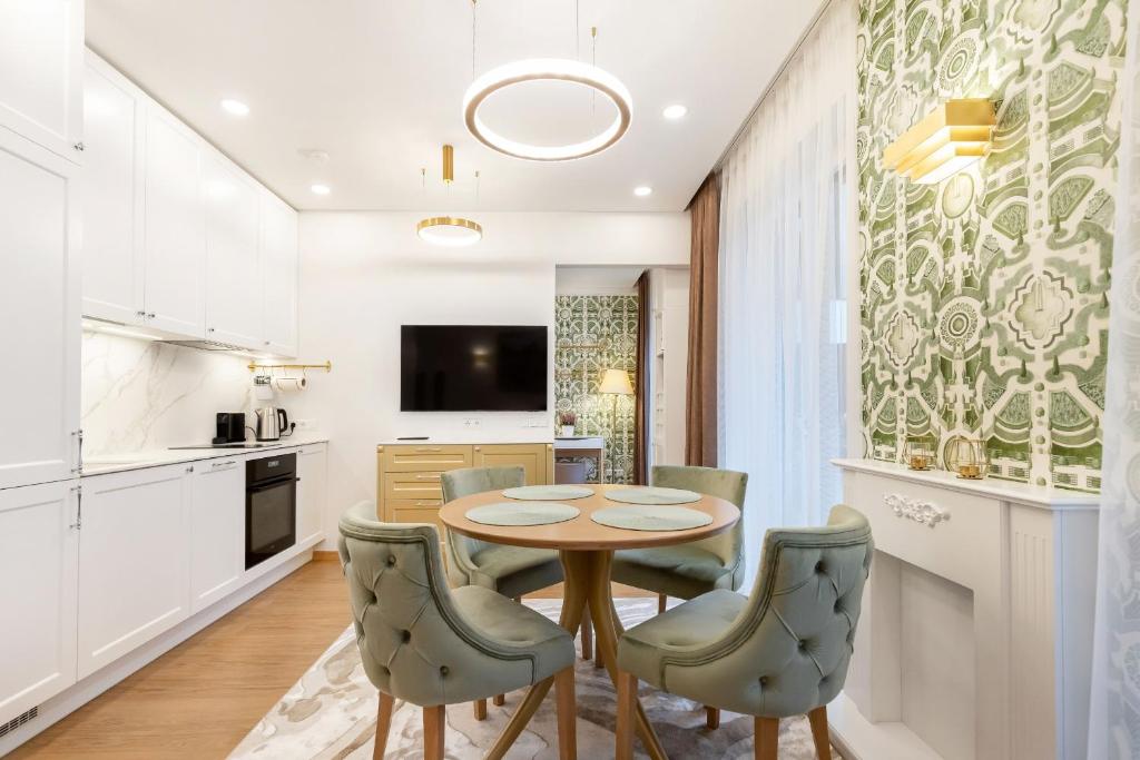 a kitchen and dining room with a table and chairs at Lux Apartment With A Terrace In Vilnius Old Town in Vilnius