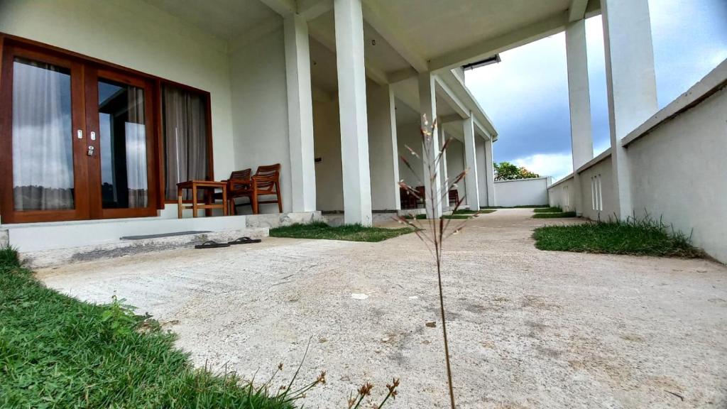 a porch of a house with a table and chairs at GREEN RINJANI in Bayan