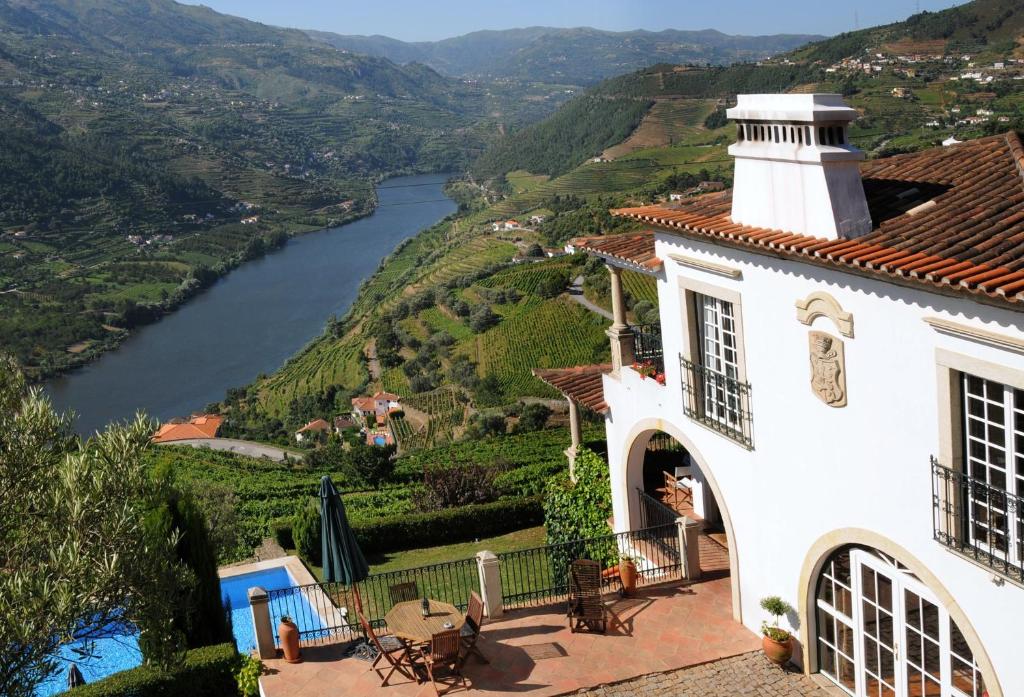 a white house with a view of a river at Casa De Canilhas in Mesão Frio