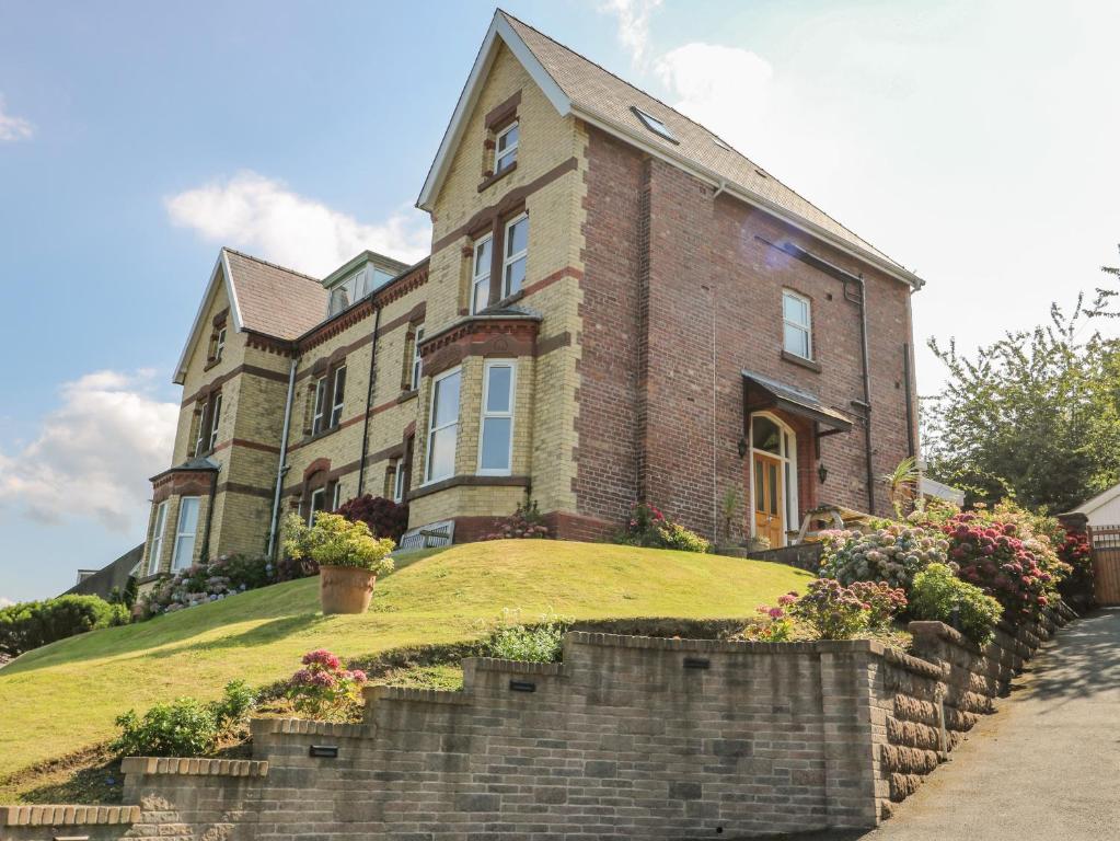 a large brick house on a grassy hill at Bryn Ogwen in Bangor