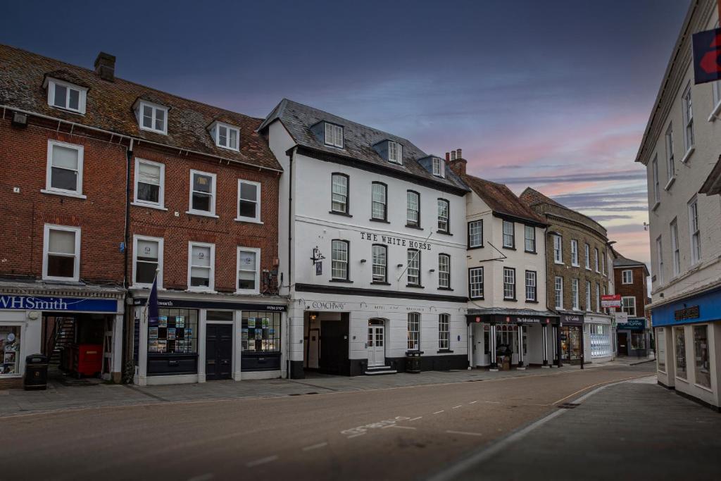 an empty city street with buildings on a street at The White Horse Hotel, Romsey, Hampshire in Romsey