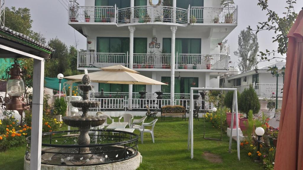 a building with a fountain in front of a building at European Complex in Bhurban