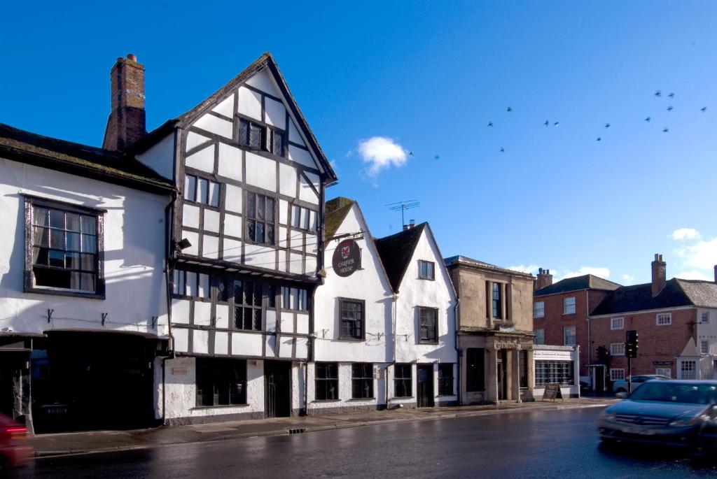 an old white and black building on a street at Chapter House in Salisbury