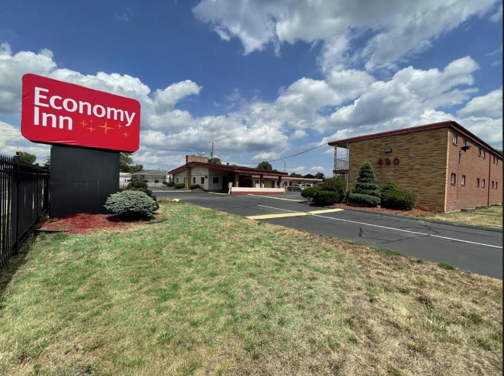 a sign for an economy inn on the side of a road at Economy Inn in East Hartford