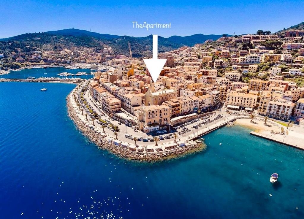 an aerial view of a city next to the water at The Apartment in Porto Santo Stefano